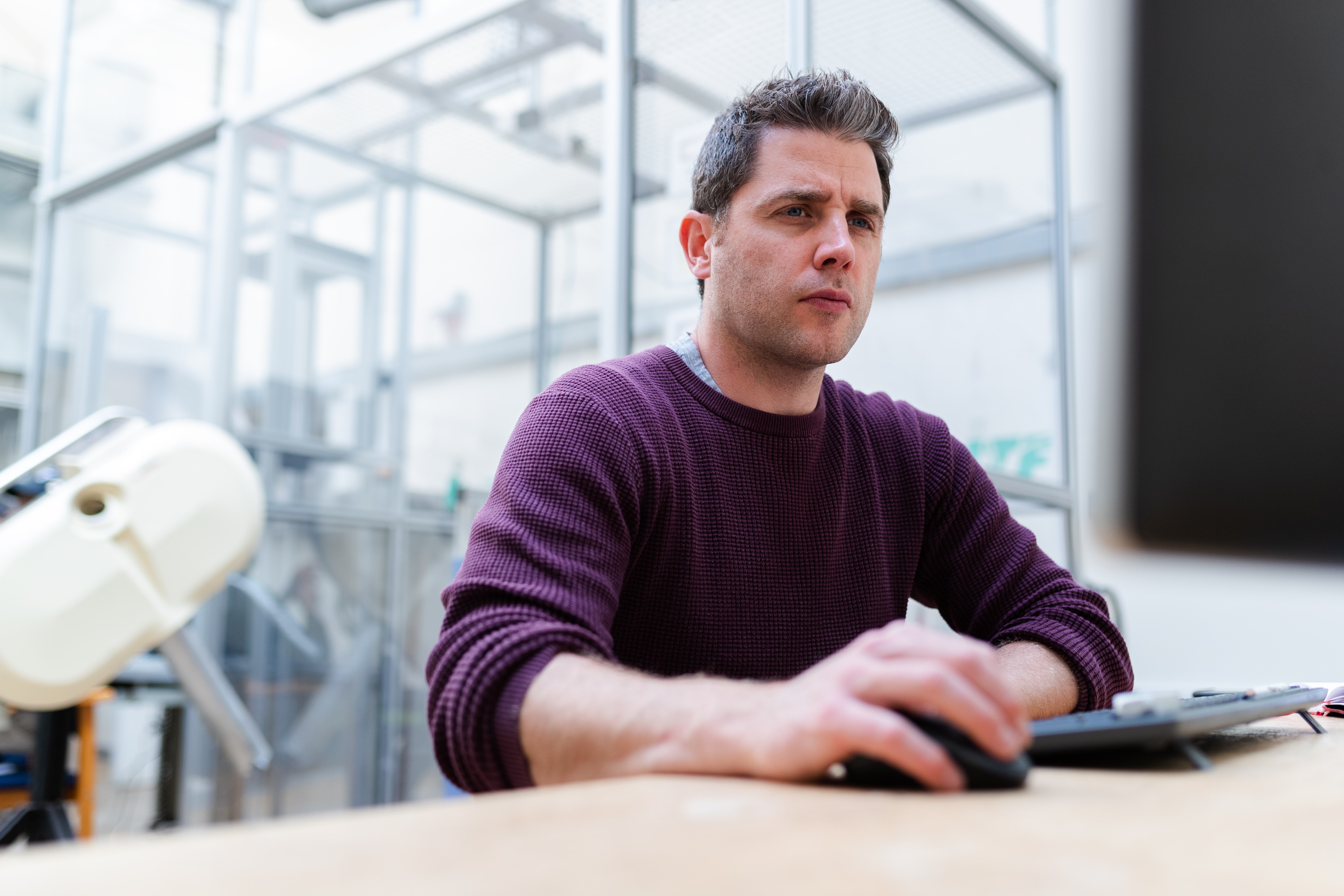 A engineer looks intrigued by his computer